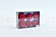 A box of six large preserved roses in a garnet red hue that are wide open