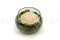 A round bowl containing a preserved peach rose set on preserved green hydrangea.