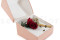 A romantic boutonniere in vibrant red tones, made with preserved flowers and foliage