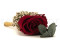 A romantic boutonniere in vibrant red tones, made with preserved flowers and foliage