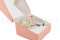 A boutonniere for a special occasion in white and cream tones, made with preserved flowers and foliage.