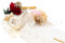 A boutonniere for a special occasion in white and cream tones, made with preserved flowers and foliage.