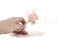 A boutonniere for a special occasion in pale pink and beige tones, made with preserved flowers and foliage.