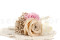 A boutonniere for a special occasion in pale pink and beige tones, made with preserved flowers and foliage.