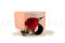 A romantic boutonniere in vibrant red tones, made with preserved flowers and foliage