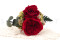 A romantic boutonniere in vibrant red tones, made with preserved flowers and foliage