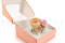 A corsage for a special occasion in pale pink and beige tones, made with preserved flowers and foliage.