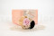 A corsage for a special occasion in pale pink and beige tones, made with preserved flowers and foliage.