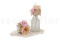 A corsage for a special occasion in pale pink and beige tones, made with preserved flowers and foliage.
