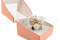 A corsage for a special occasion in white and cream tones, made with preserved flowers and foliage.